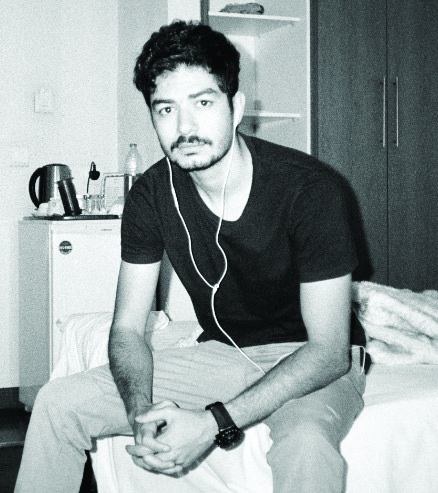 Black-and-white portrait of Arad Shahpazir, seated indoors