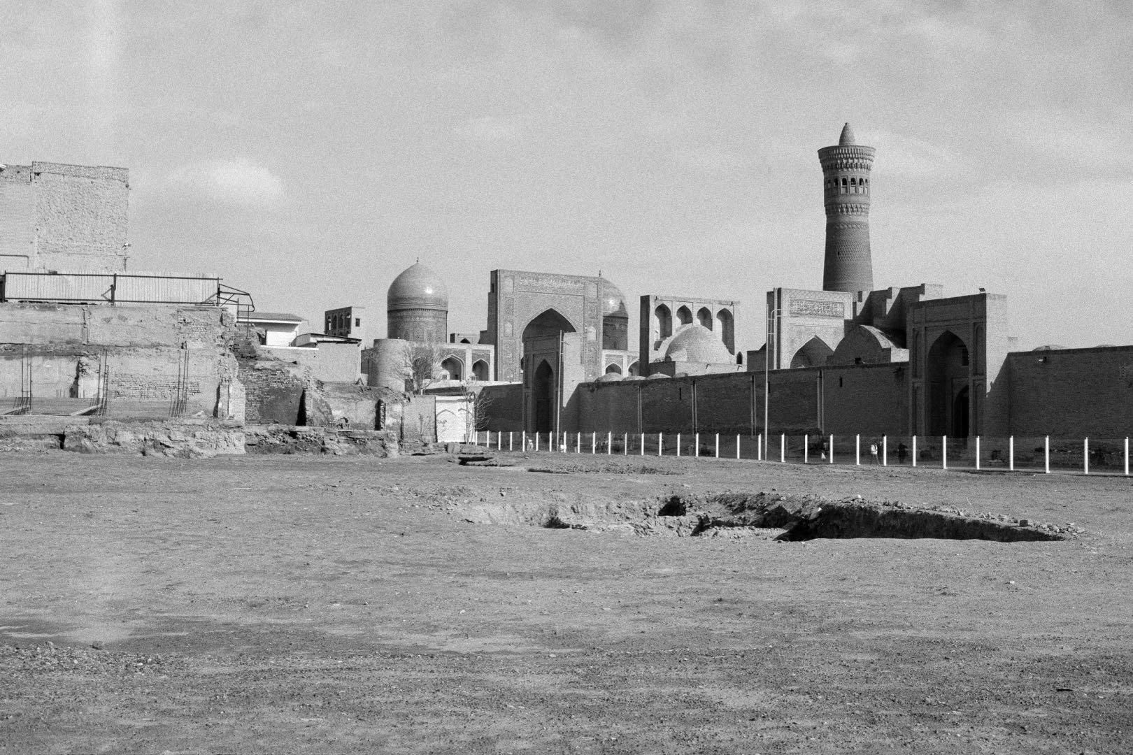 Black-and-white photograph: At the Foot of the Great One, Bukhara, Uzbekistan, 2024